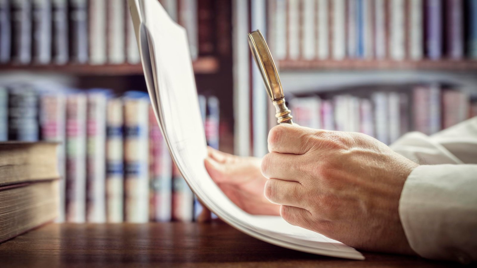 Businessman reading documents with magnifying glass concept for analyzing a finance agreement or legal contract